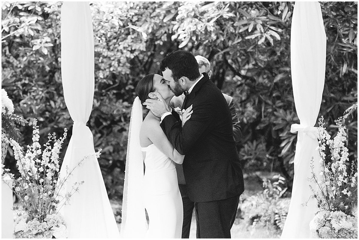 Black and White of Bride and Groom First Kiss Photo