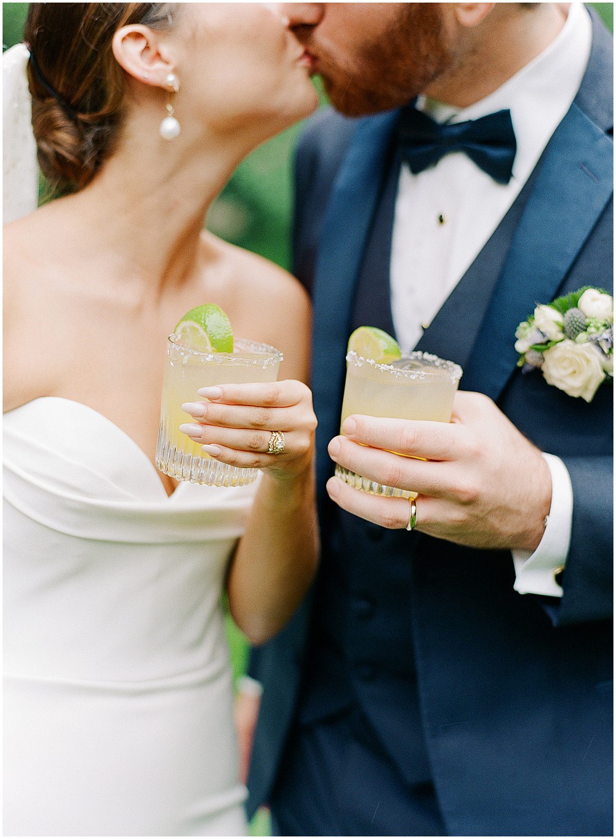 Bride and Groom Kissing Holding Cocktails Photos