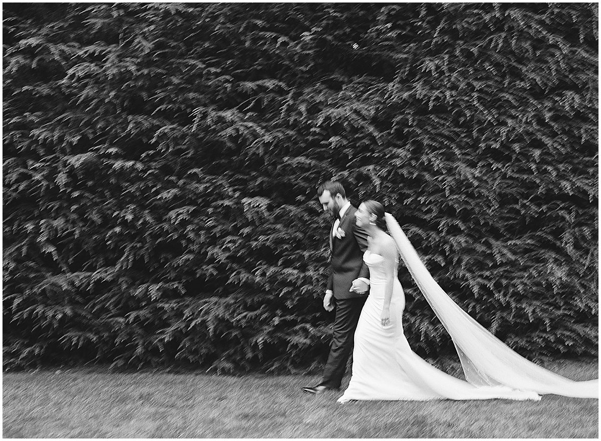 Black and White of Bride and Groom Walking Photo