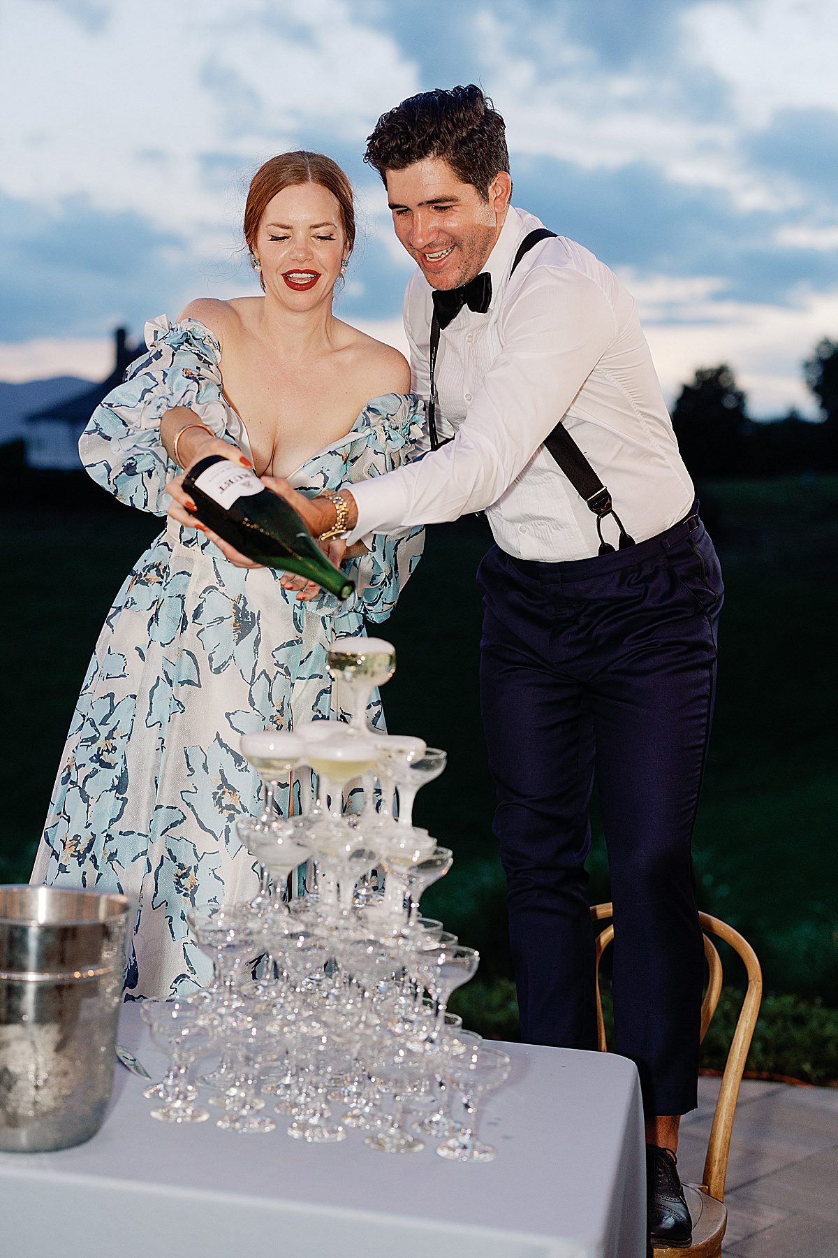 Bride and Groom Pouring Champagne Tower at Wedding Reception Photo