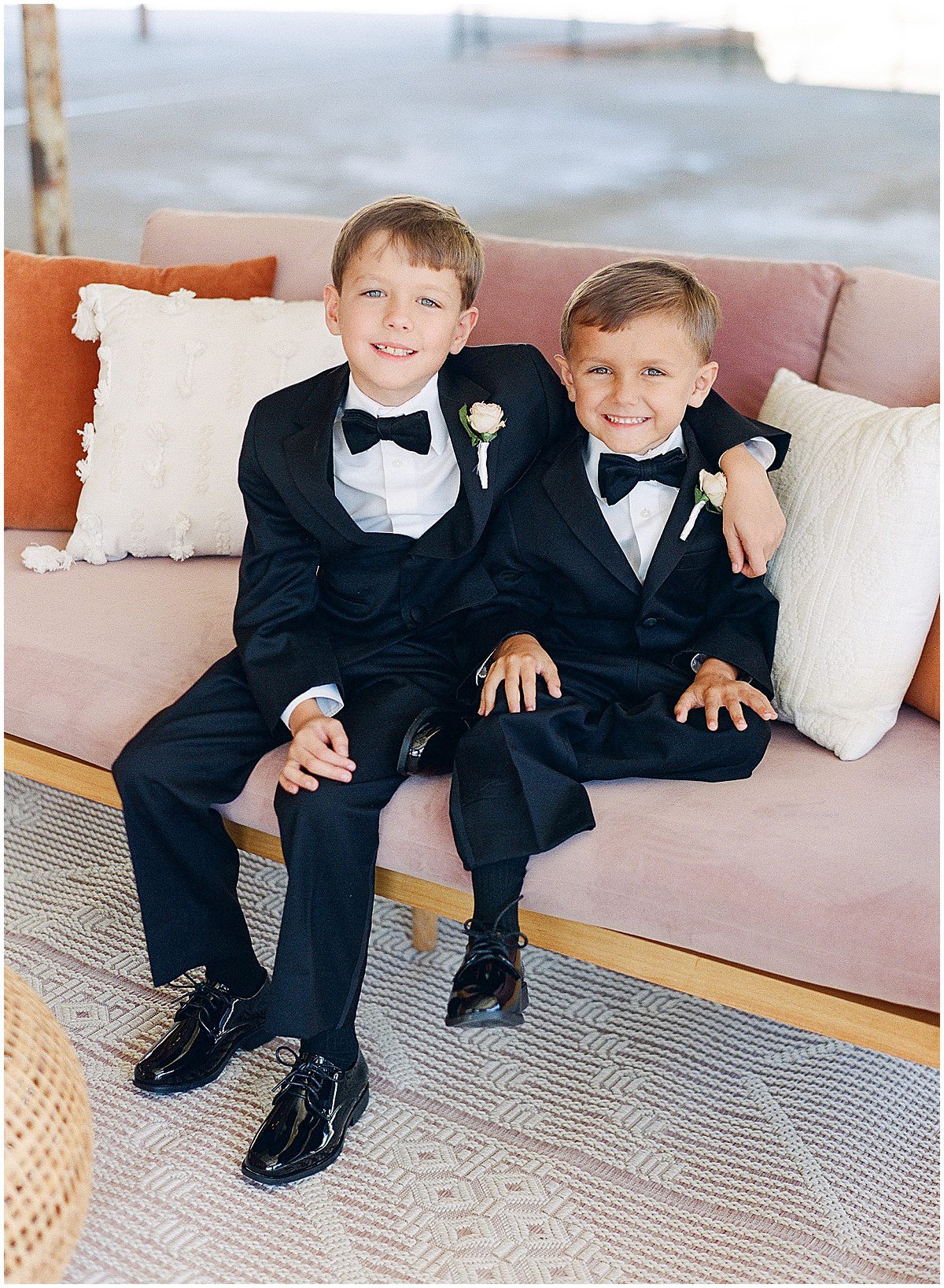 Ring Bearers Smiling Sitting on Pink Couch Photo