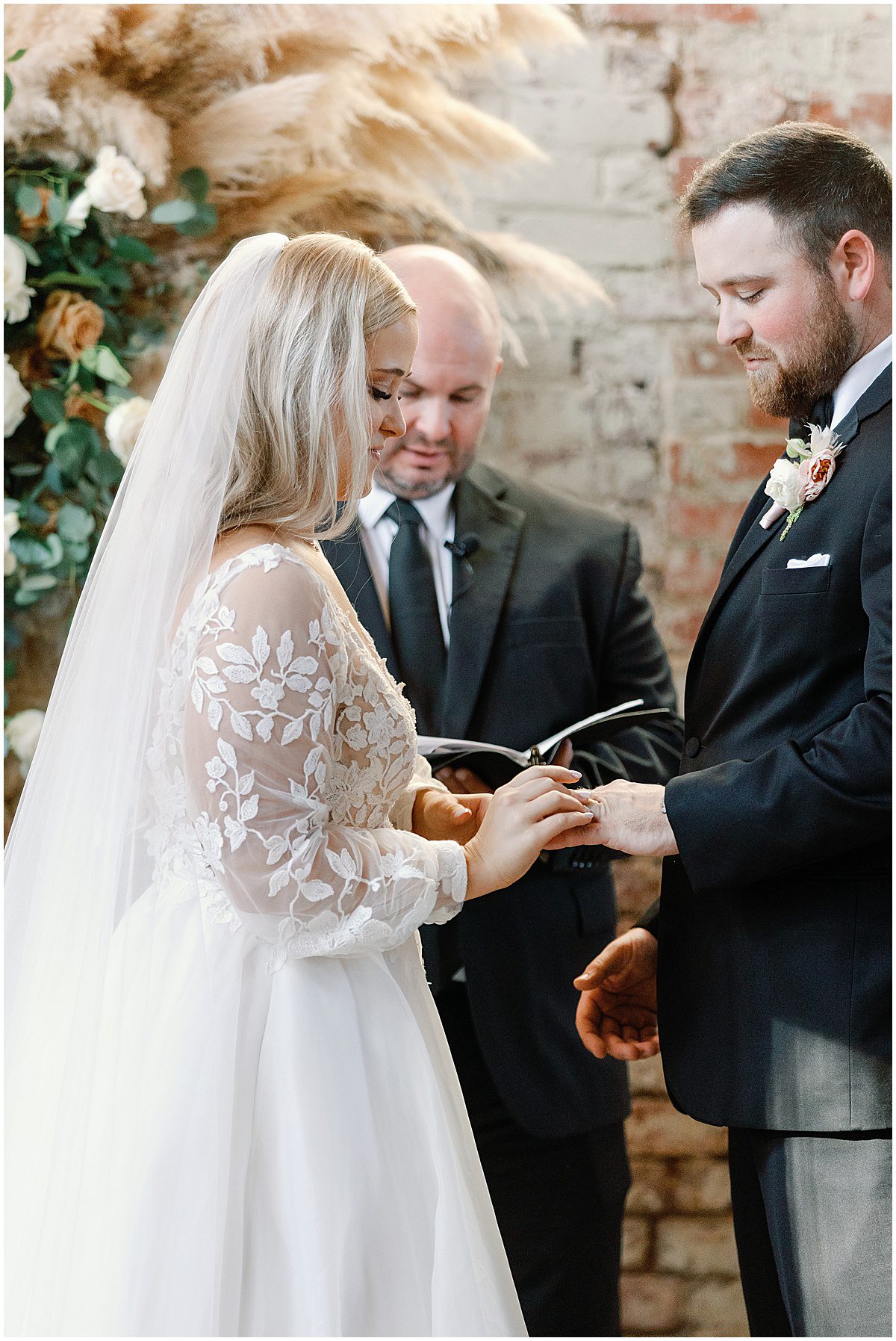 Bride and Groom Giving Rings At Wedding Ceremony Photo