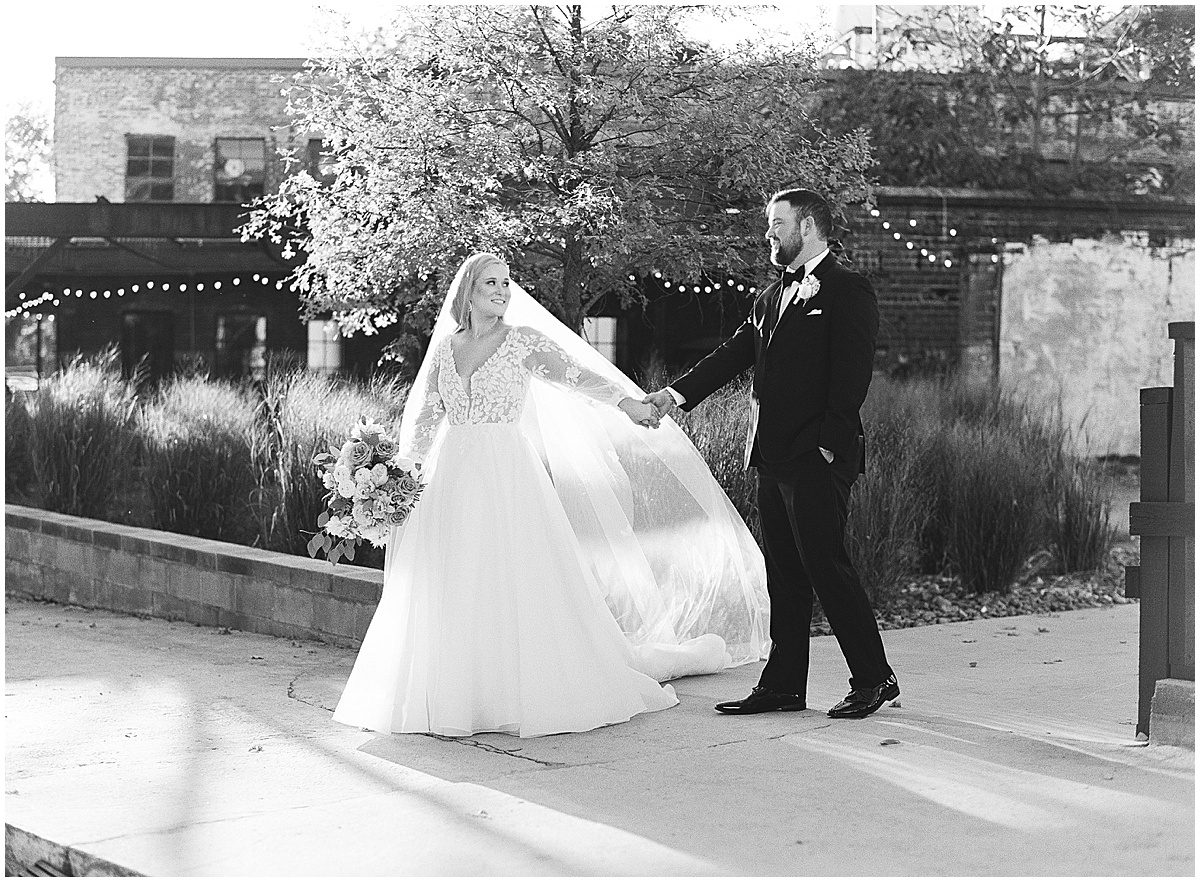 Black and White of Bride and Groom Walking at Guardian Works Wedding Venue in Atlanta Photo