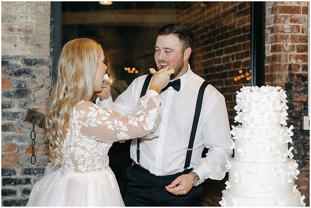 Bride and Groom Eating Cake Photo