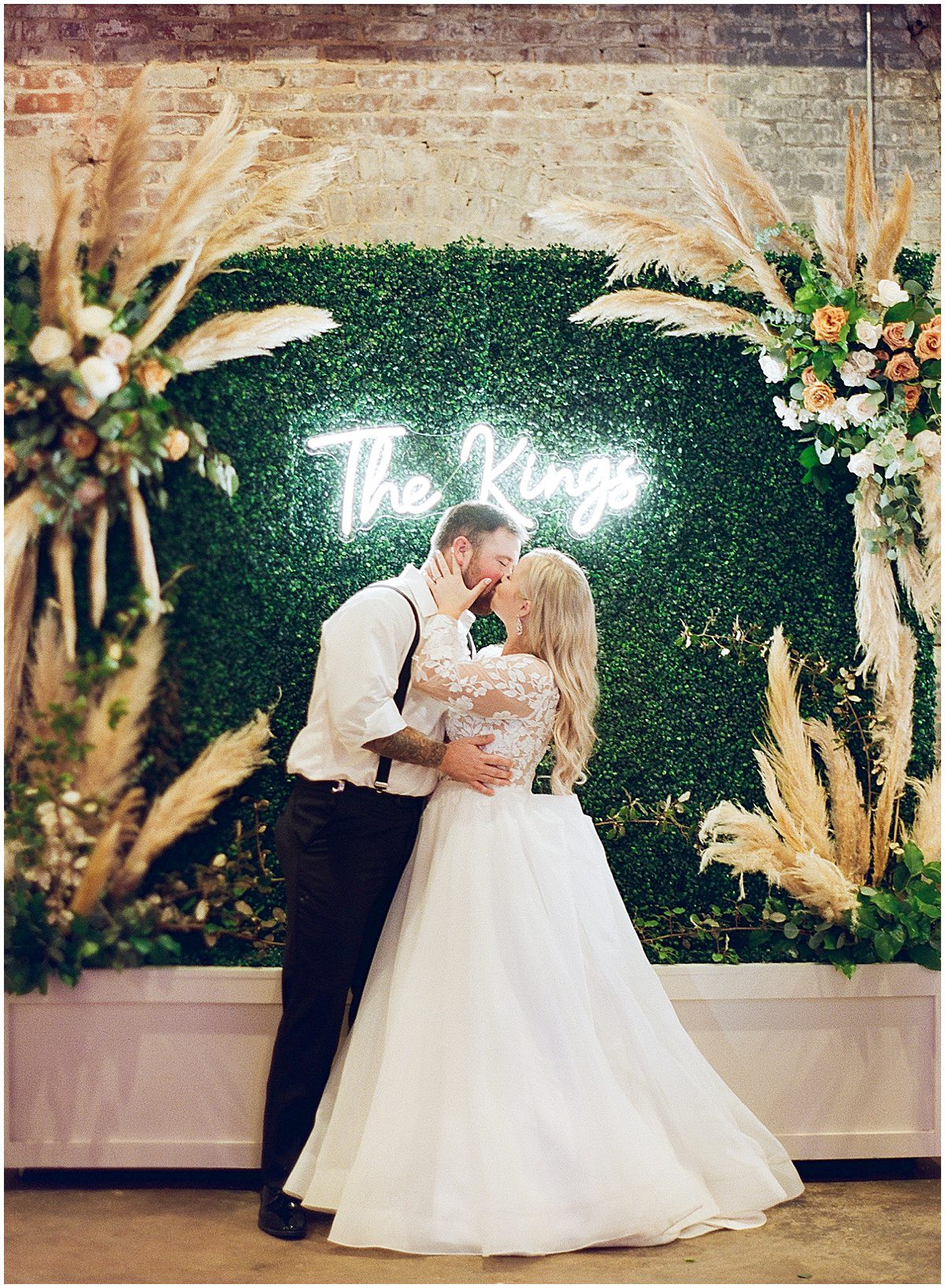 Bride and Groom in Front of Neon Sign Photo