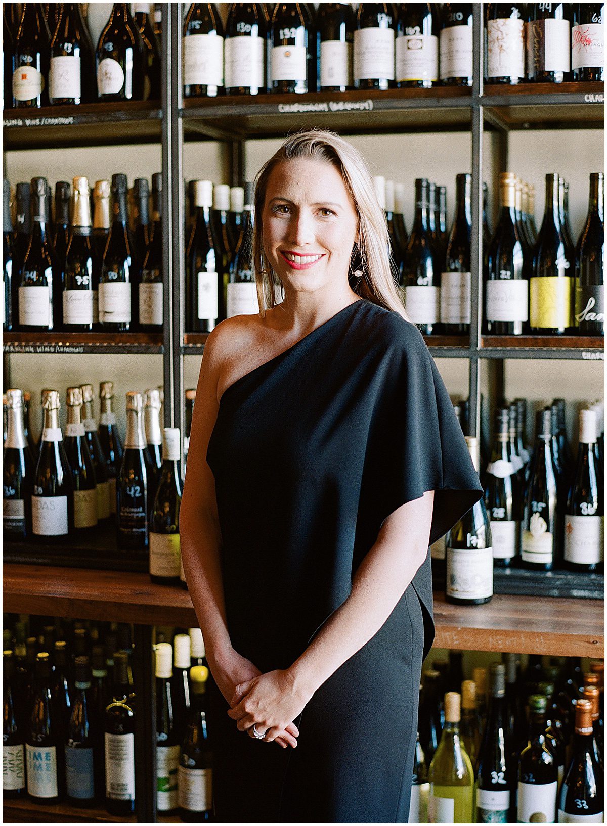 Charleston Wedding Planner in Front of Bottles of Wine Photo