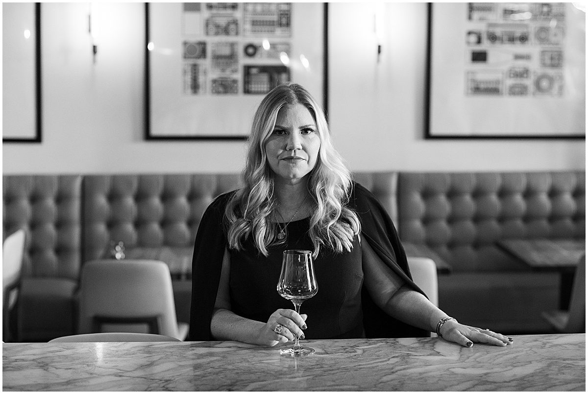 Black and White of Woman with Wine Glass at Bar Photo