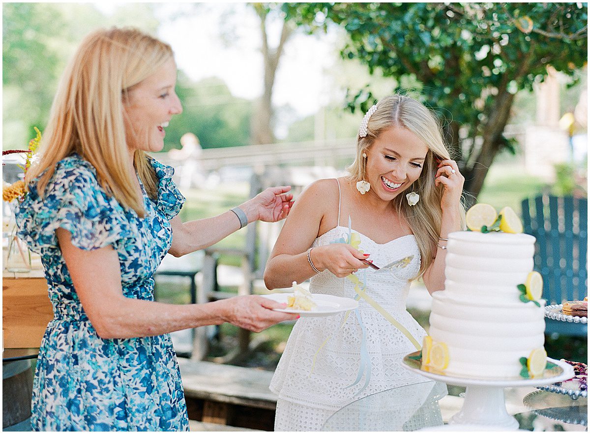 Bride and Mother of Bride Cutting Cake at Bridal Shower Photo