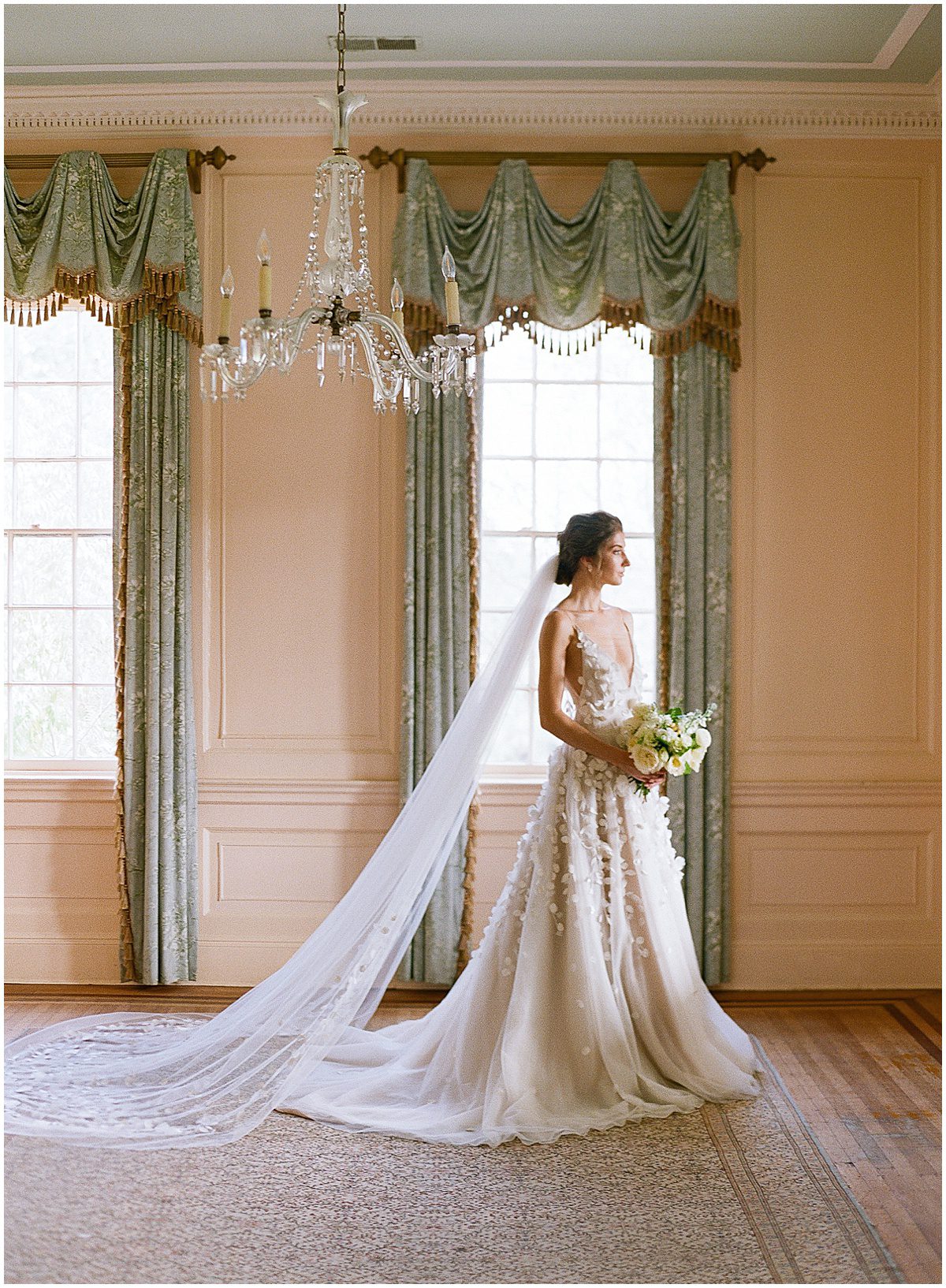 Bride Looking Out Window Holding Flowers at Lowndes Grove Photo