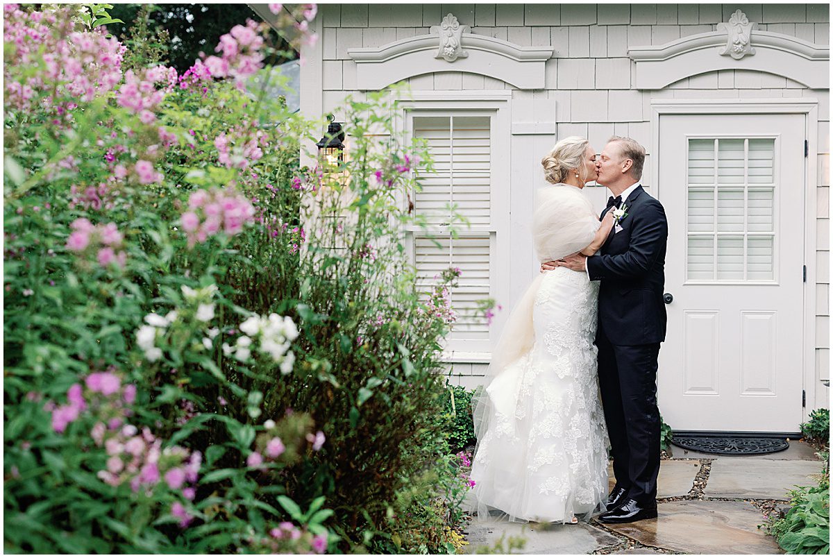 Bride and Groom Kissing in The Garden at The Farm at Old Edwards Inn Photo