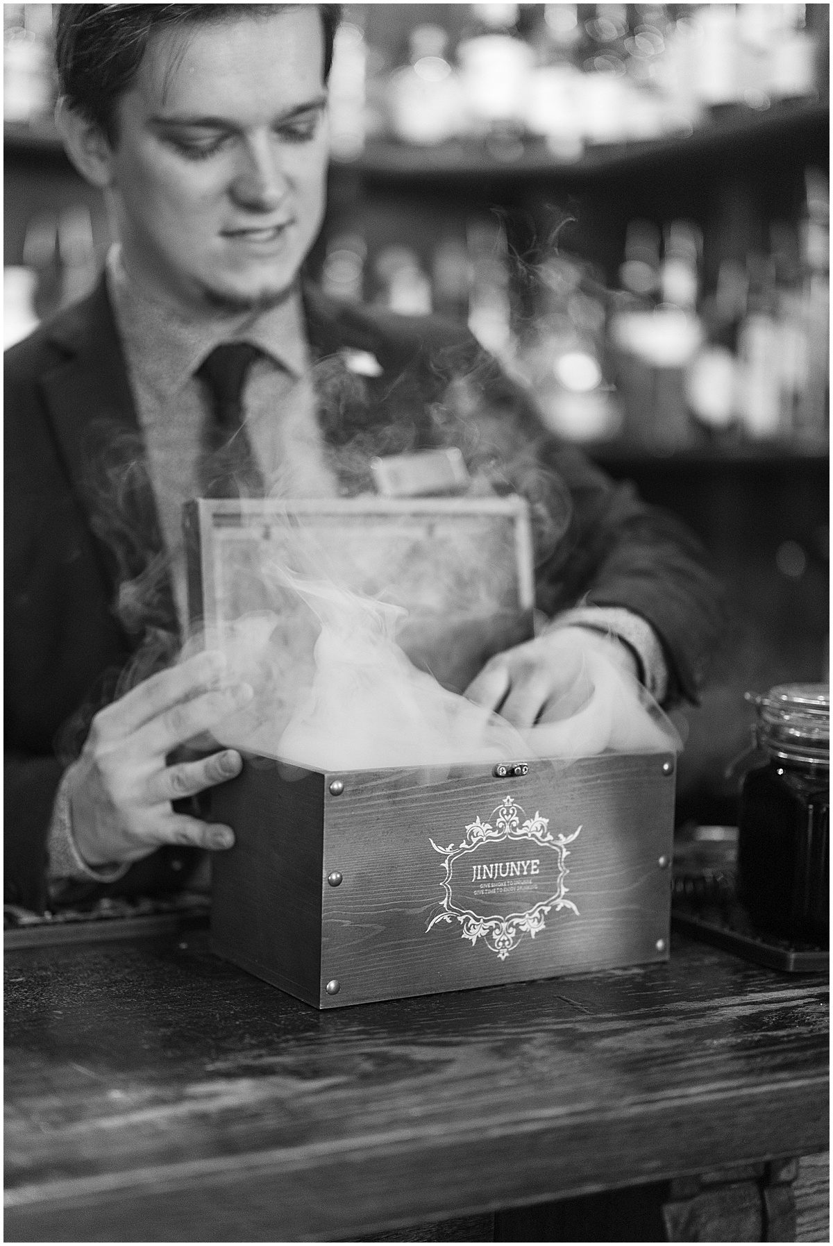 Black and White of Bar Tender Serving Smoked Old Fashions Photo