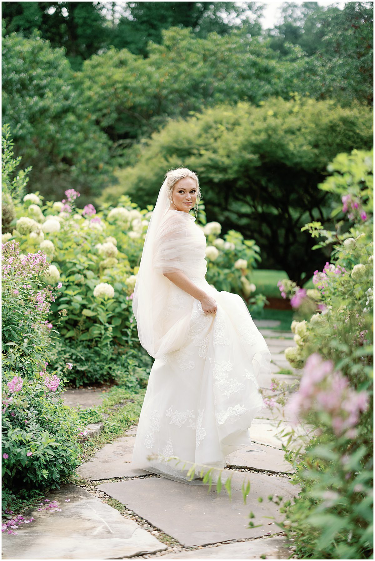 Bride Looking Over Shoulder In The Garden of Old Edwards Inn Photo
