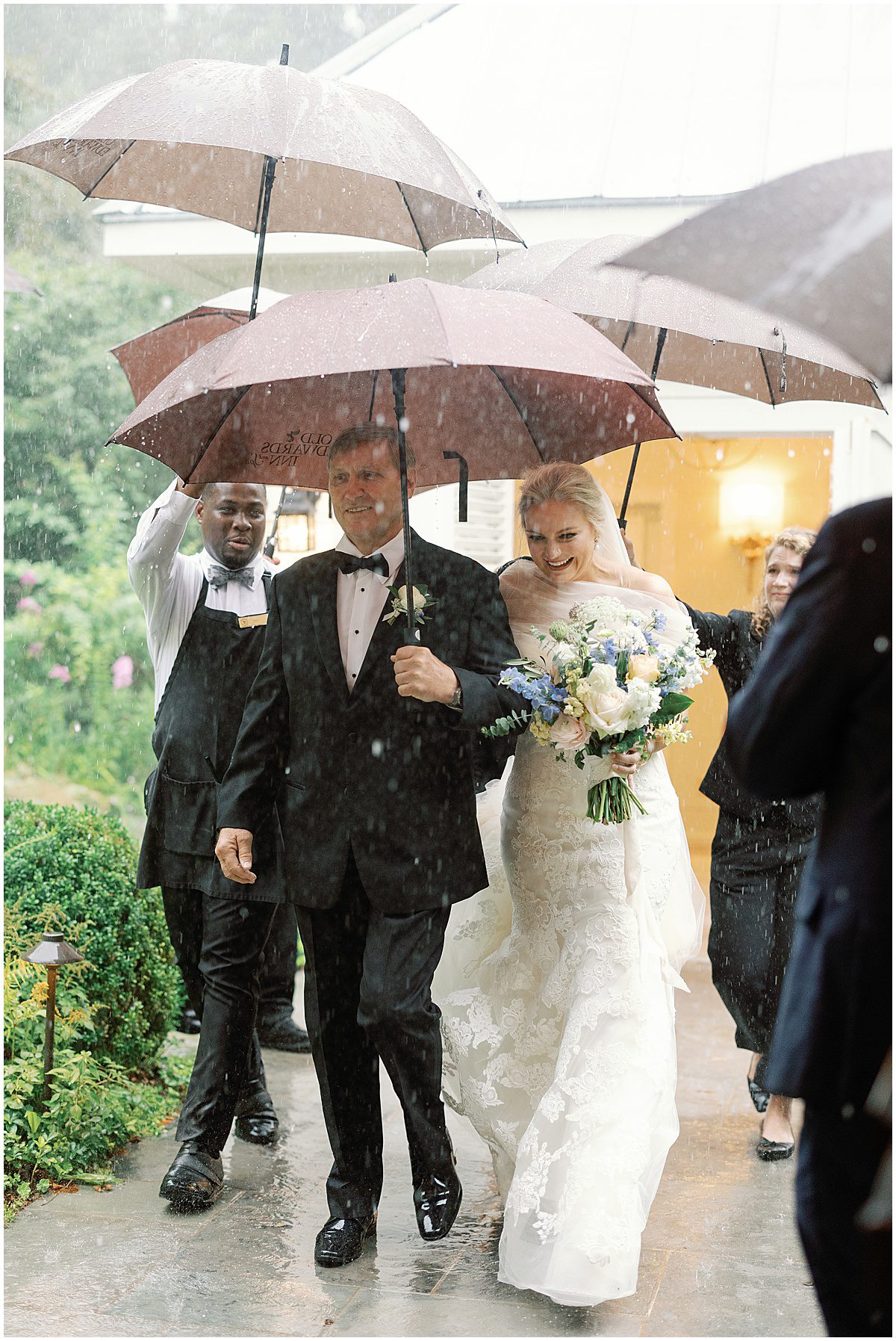 Bride and Father Walking through Rain to get to Wedding Ceremony Photo
