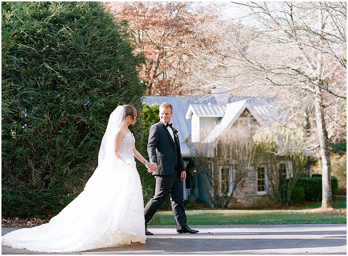 Bride and Groom Holding Hands Walking along road Photo