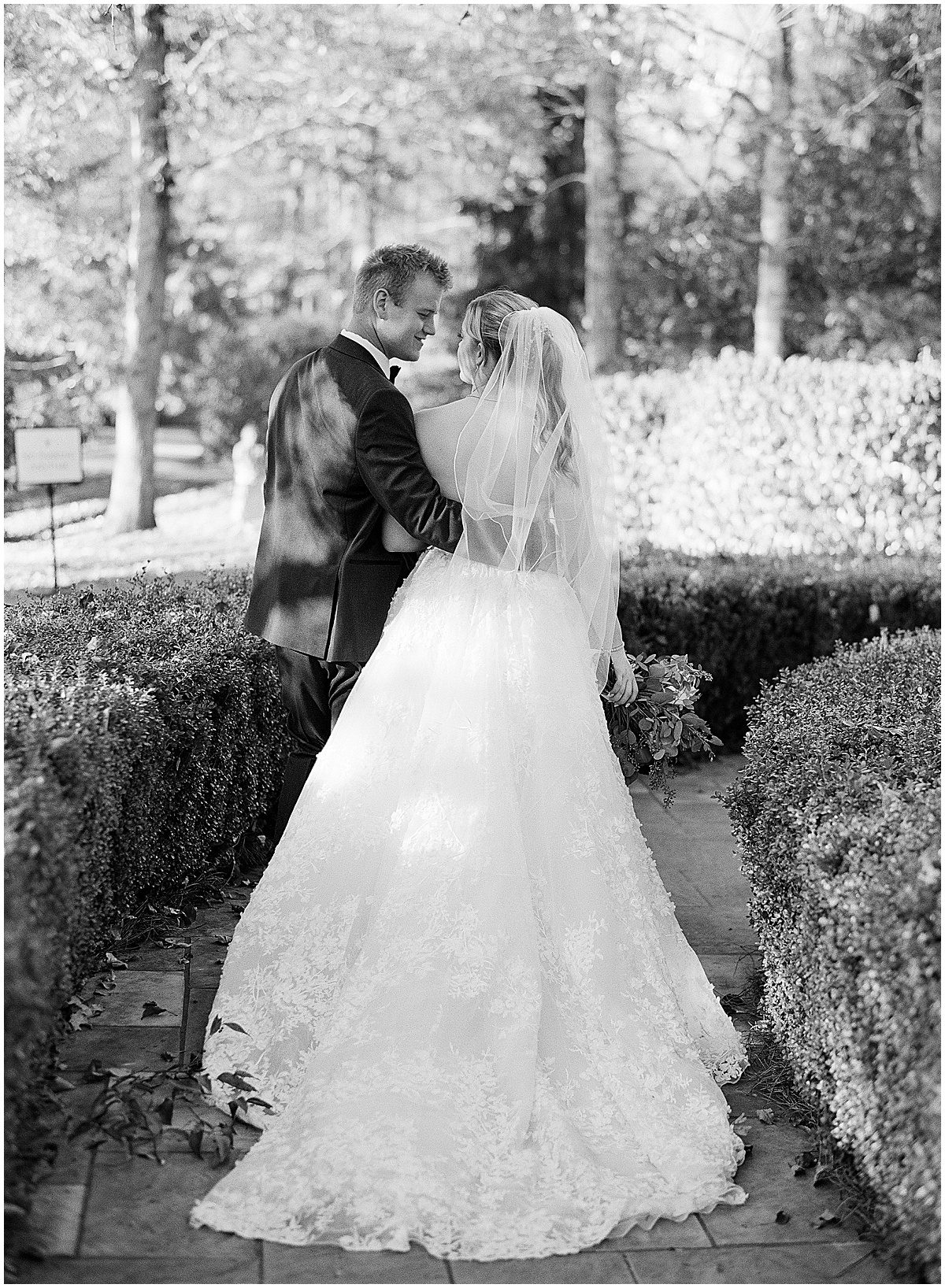 Black and White of Bride and Groom Walking Along Path Photo