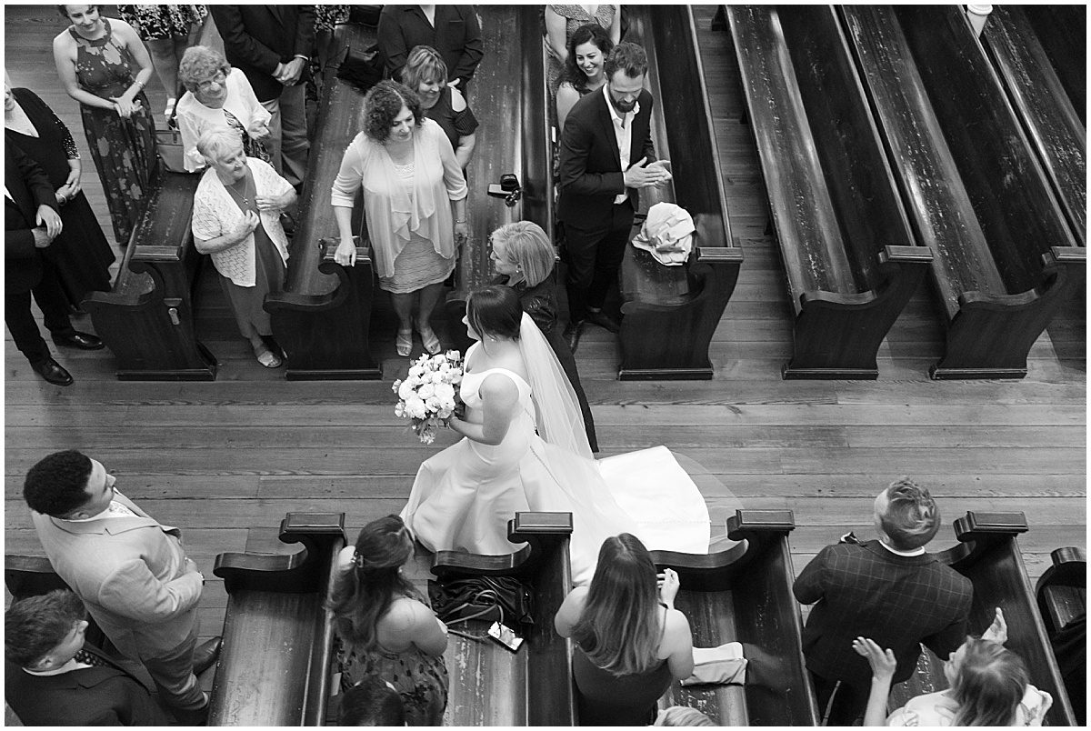 Black and White of Bride and Her Mom Walking Down Aisle Photo