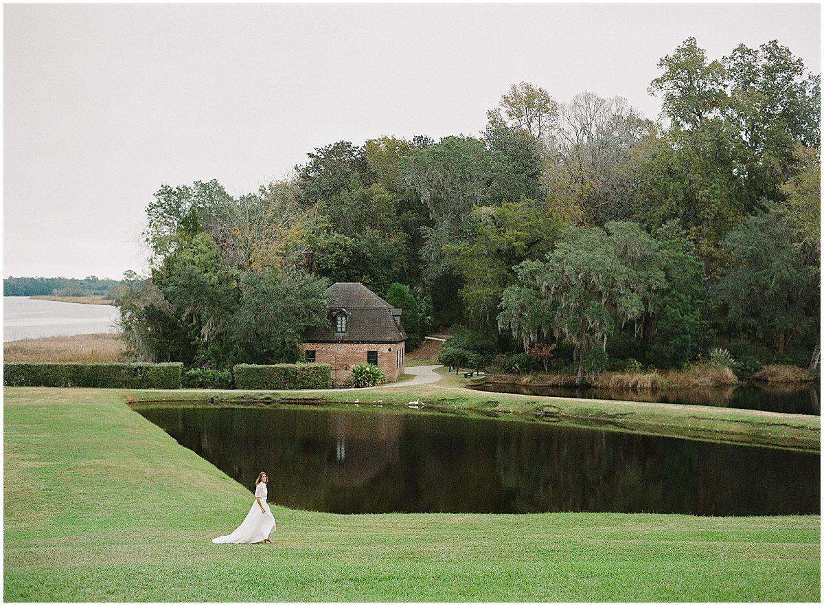 Bride Walking in front of Butterfly Lakes at Middleton Place Photo