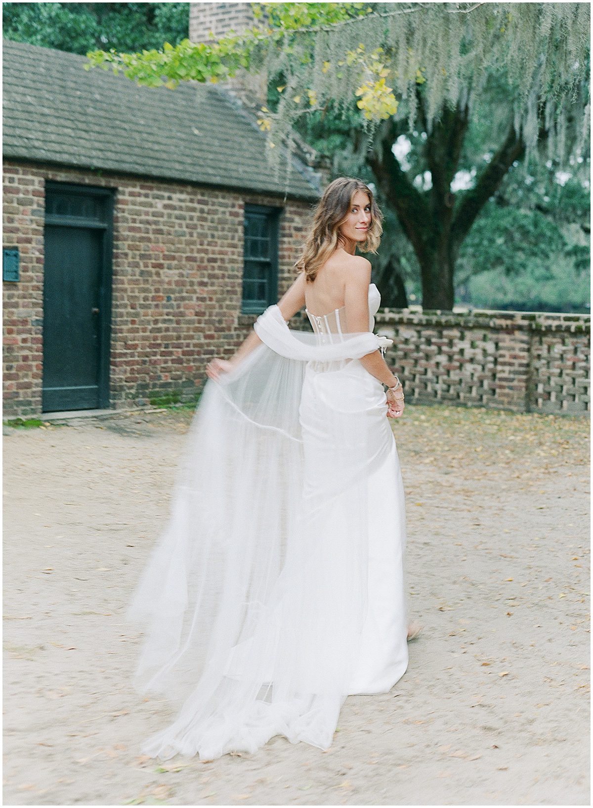Bride Looking over Shoulder walking away from Camera at Middleton Place Photo