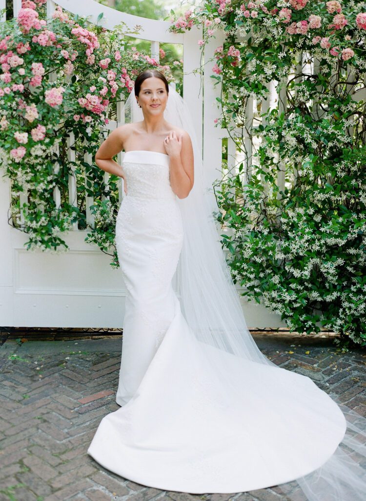 Bride in front of wisteria covered gate photo
