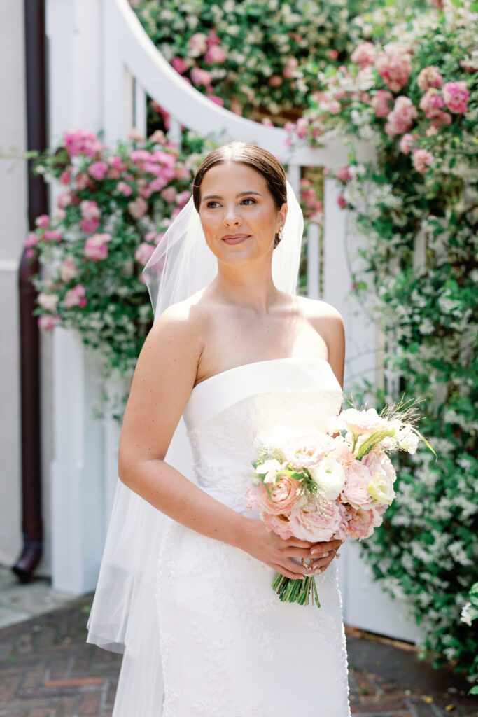 Bride Looking over her shoulder holding bouquet photo