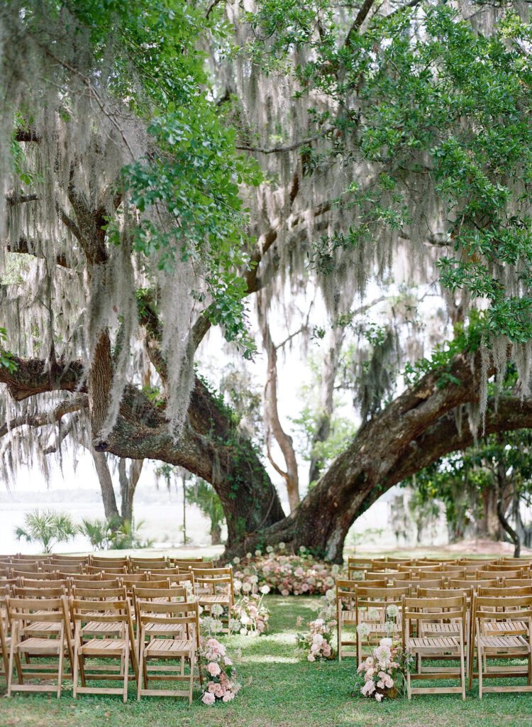 wedding ceremony set up in front of large oak tree with Spanish moss