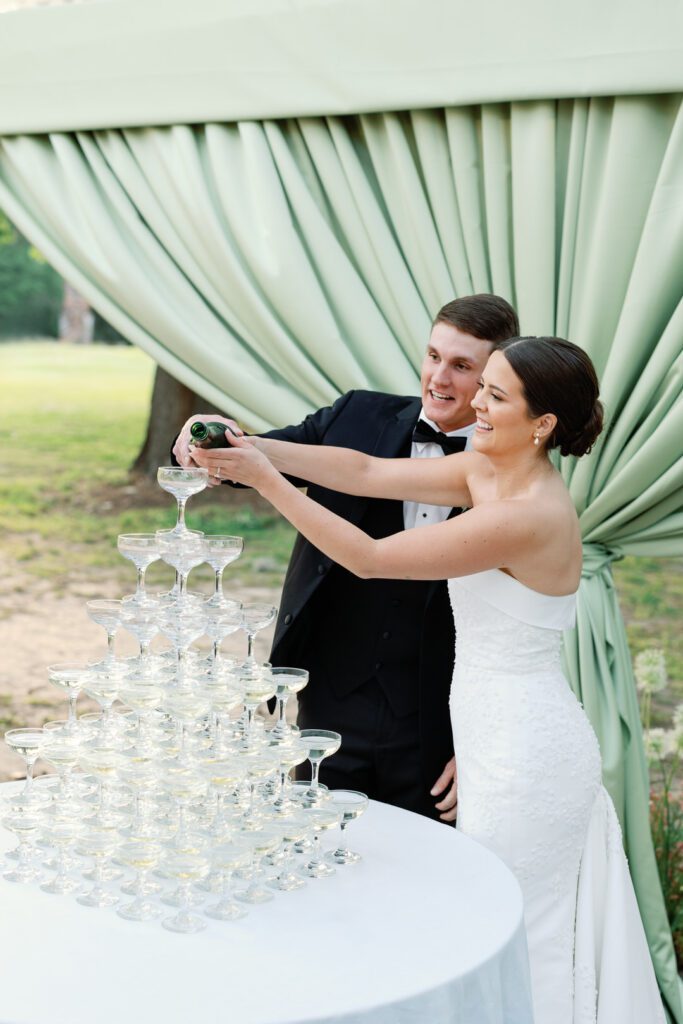 Bride and Groom pouring champagne in champagne tower