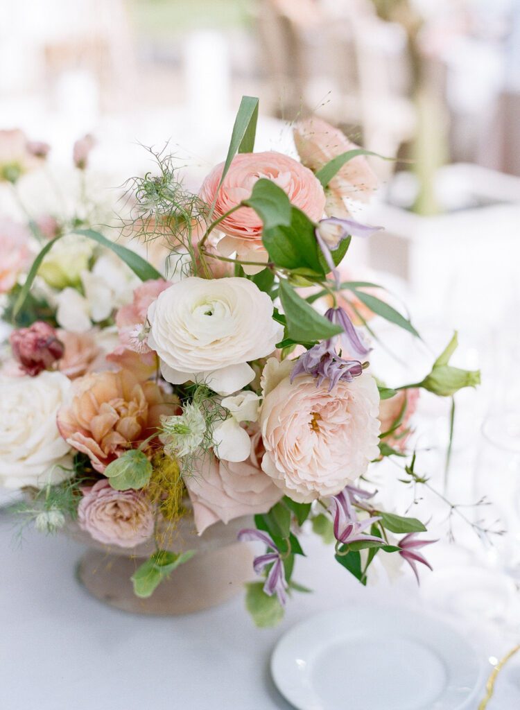 Wedding reception flower centerpiece on table with pastel colors