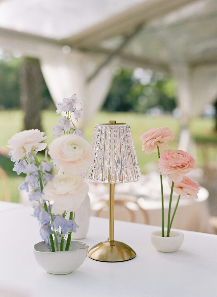 wedding reception florals and mini lamp on bar