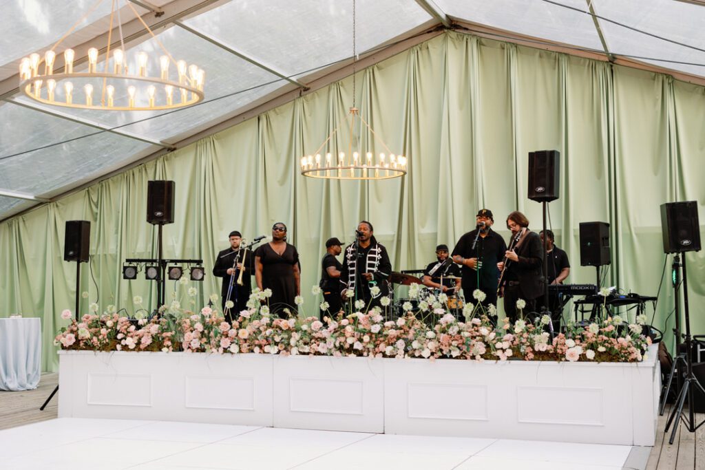 Wedding reception stage and band playing during Runnymede wedding in Charleston, SC