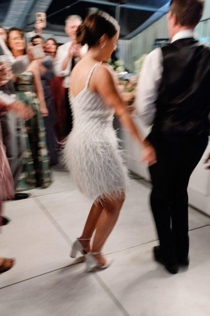 bride dancing in wedding reception short beaded dress