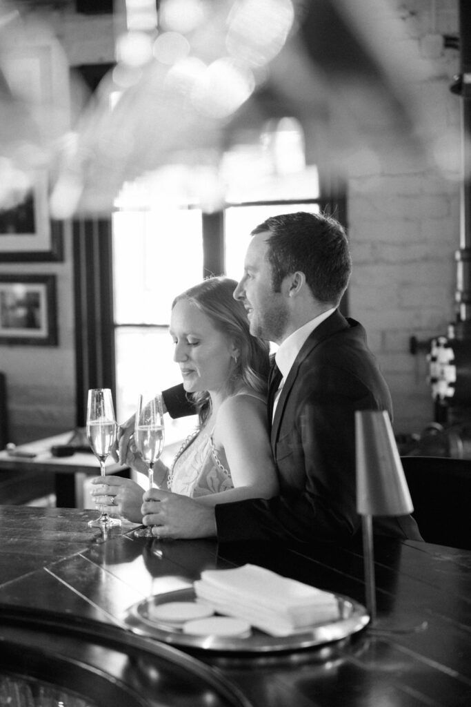 black and white of couple sitting at bar