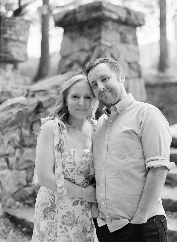 black and white of couple smiling at camera