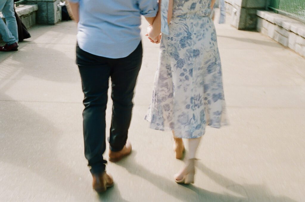 couple holding hands walking