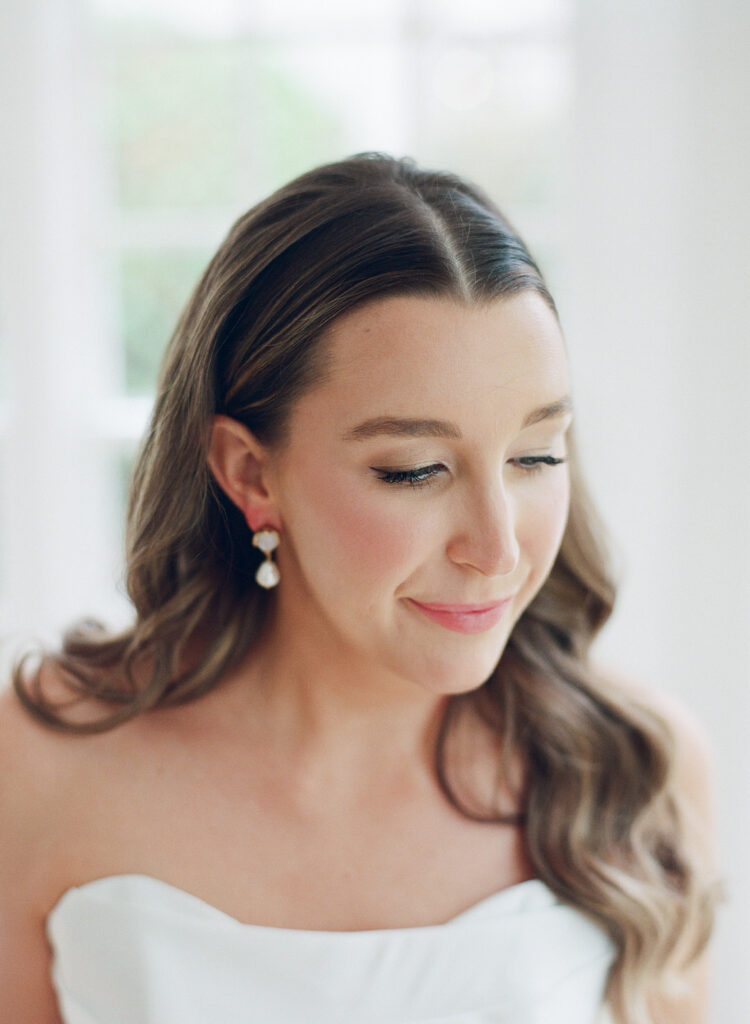 Bride's portrait of her looking down.
Atlanta Wedding Hair and Makeup Artist by Rachel Carter Beauty.
