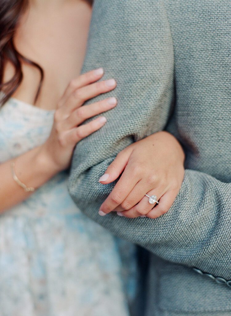 Bride's hands holding grooms elbow