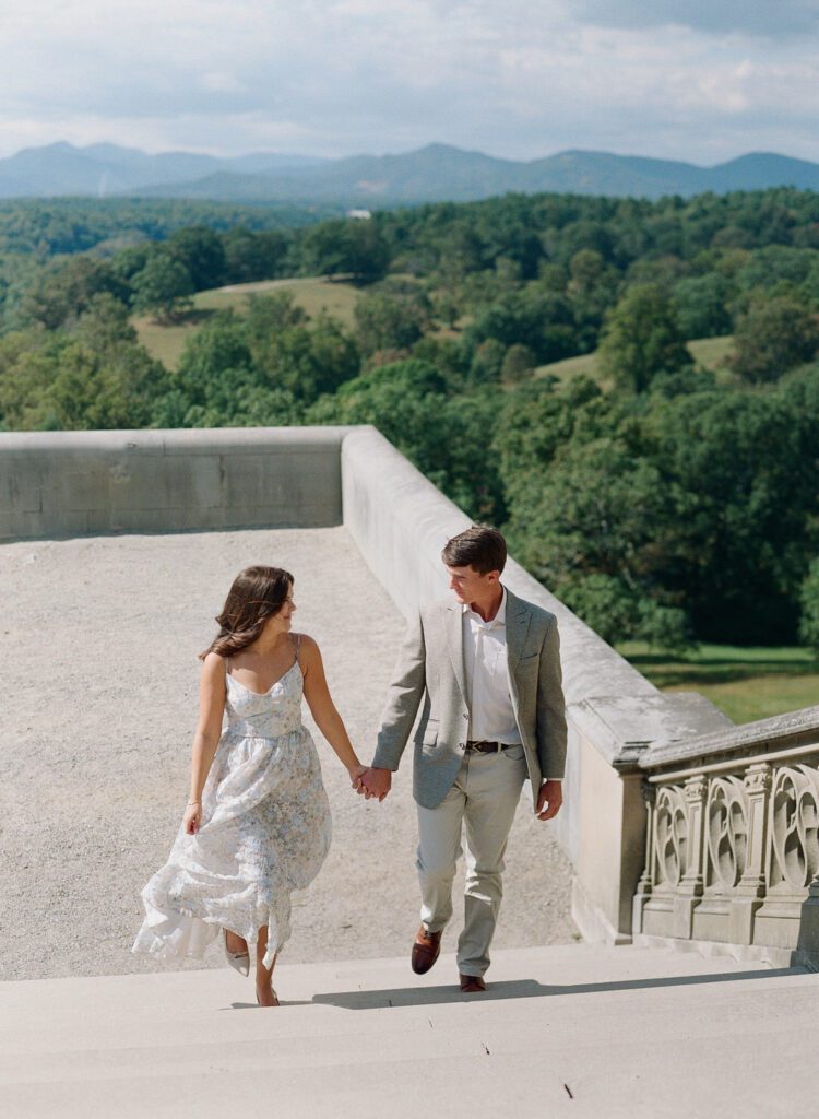 Couple holding hands walking up Biltmore Steps