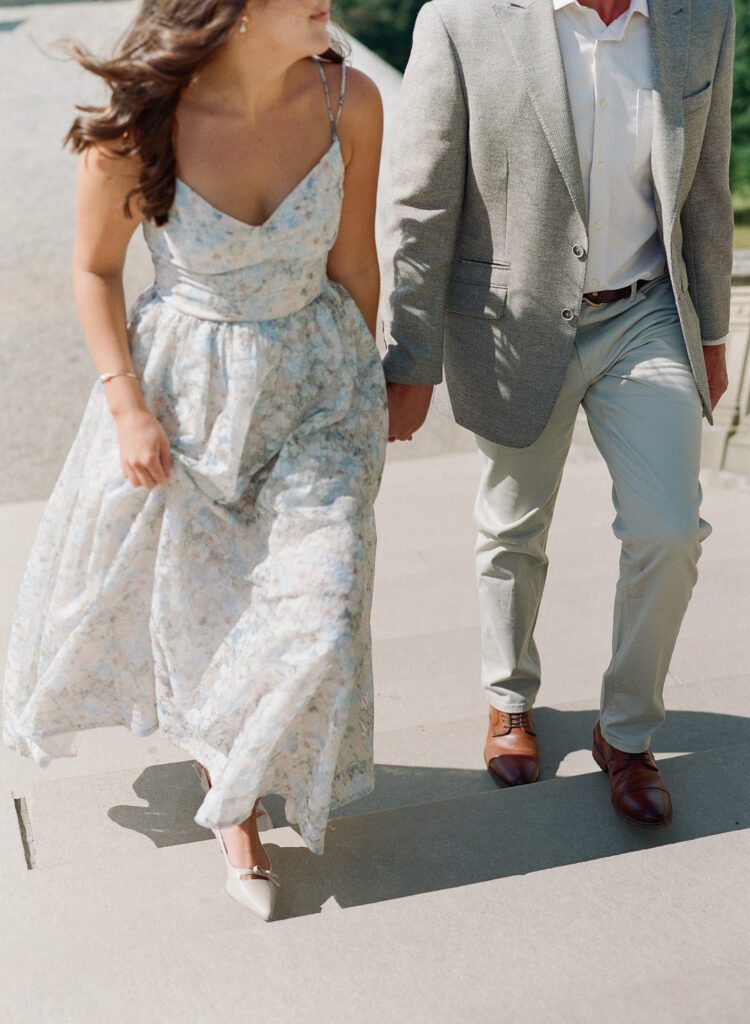 Couple holding hands walking up stairs at Biltmore