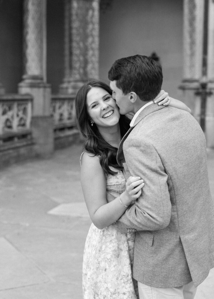 black and White of groom kissing bride on the cheek