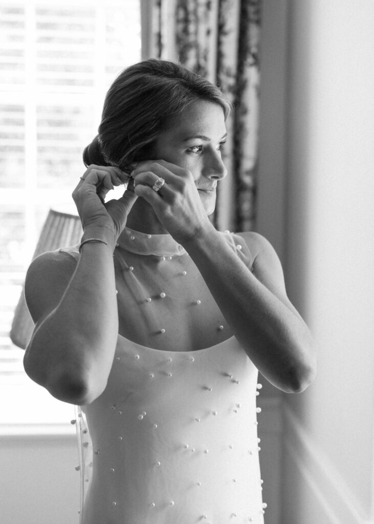 black and white of bride getting ready 