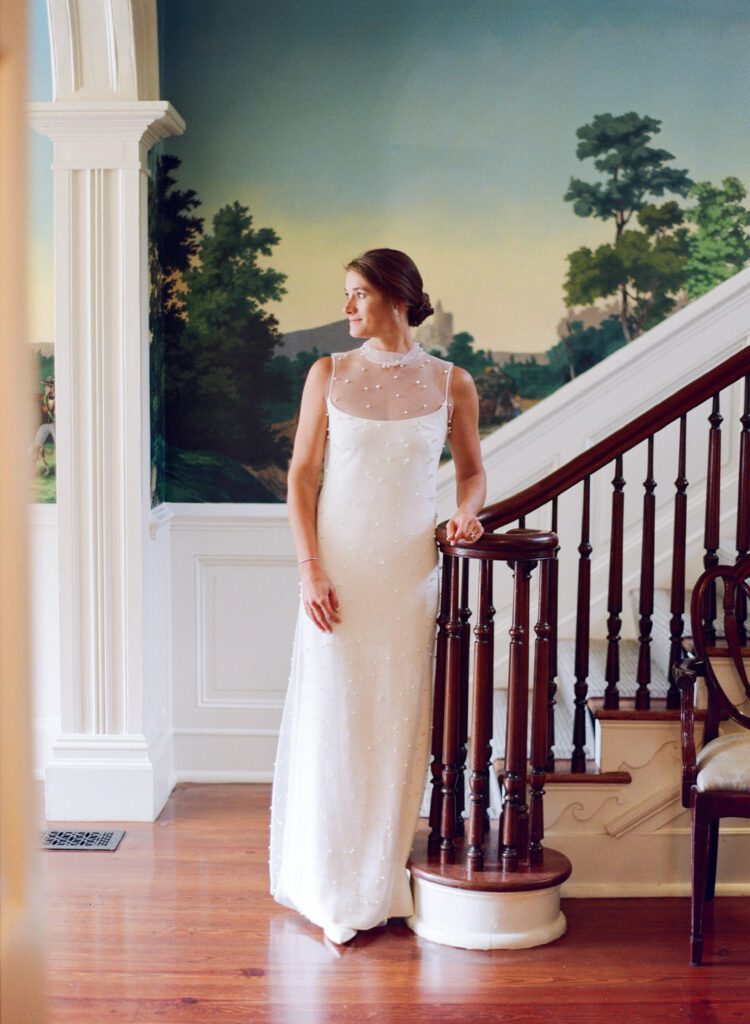 bride standing at the bottom of stairs at Bray's Island Plantation 