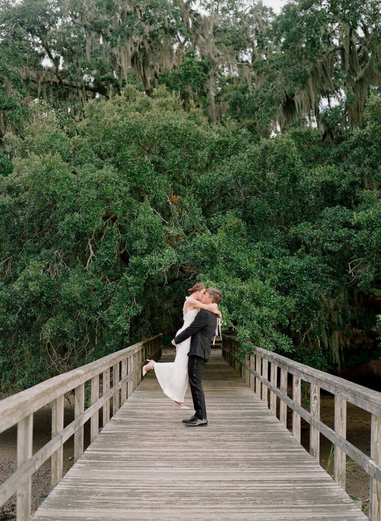 groom picking bride up kissing