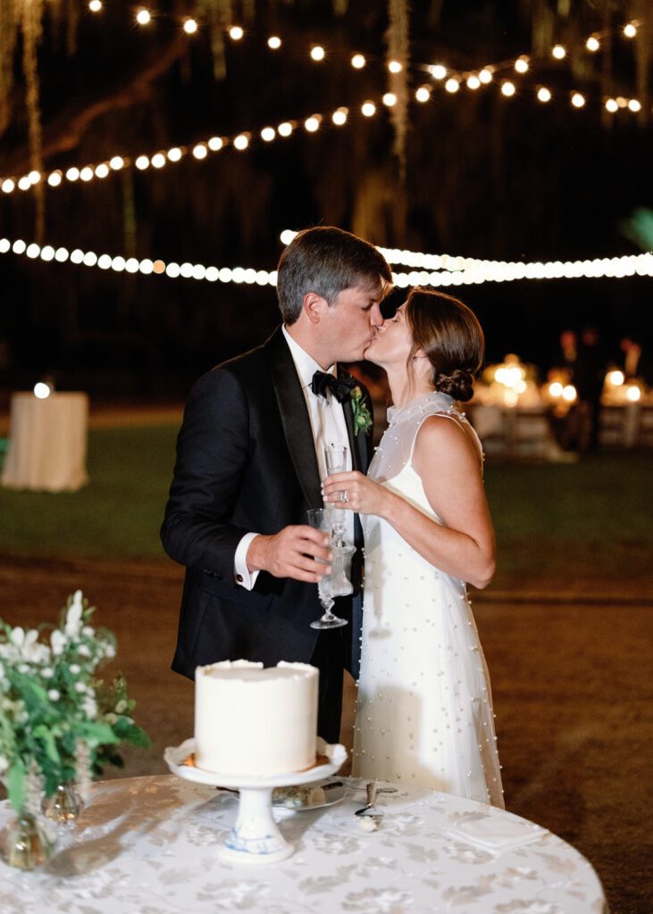 Bride and Groom kissing at Cake 