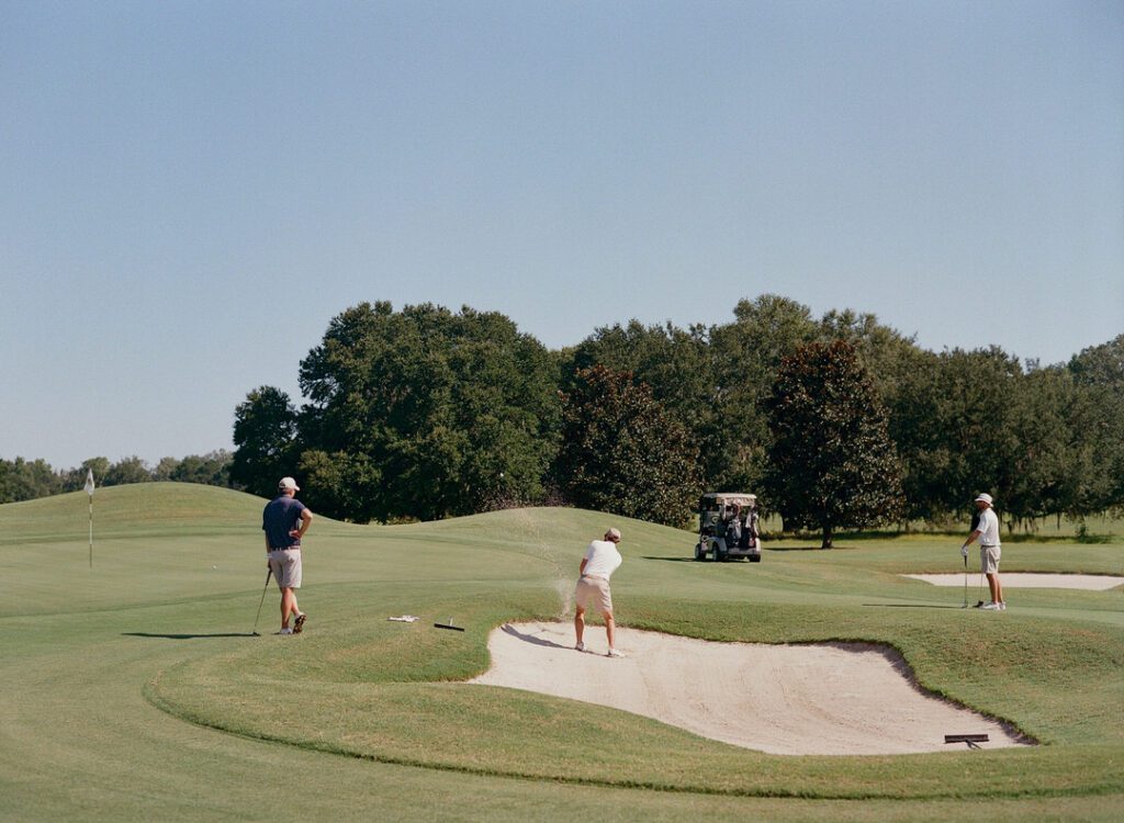 groom with groomsmen playing golf 