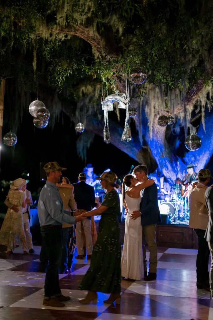 bride and groom kissing on dance floor 