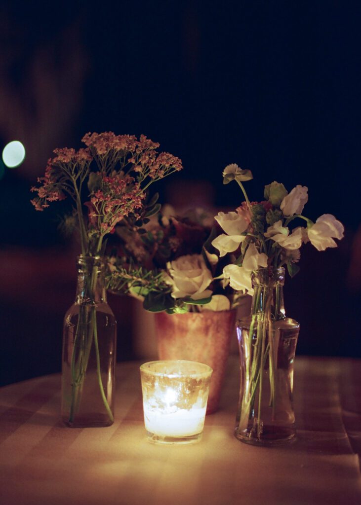 candle and flowers on table 