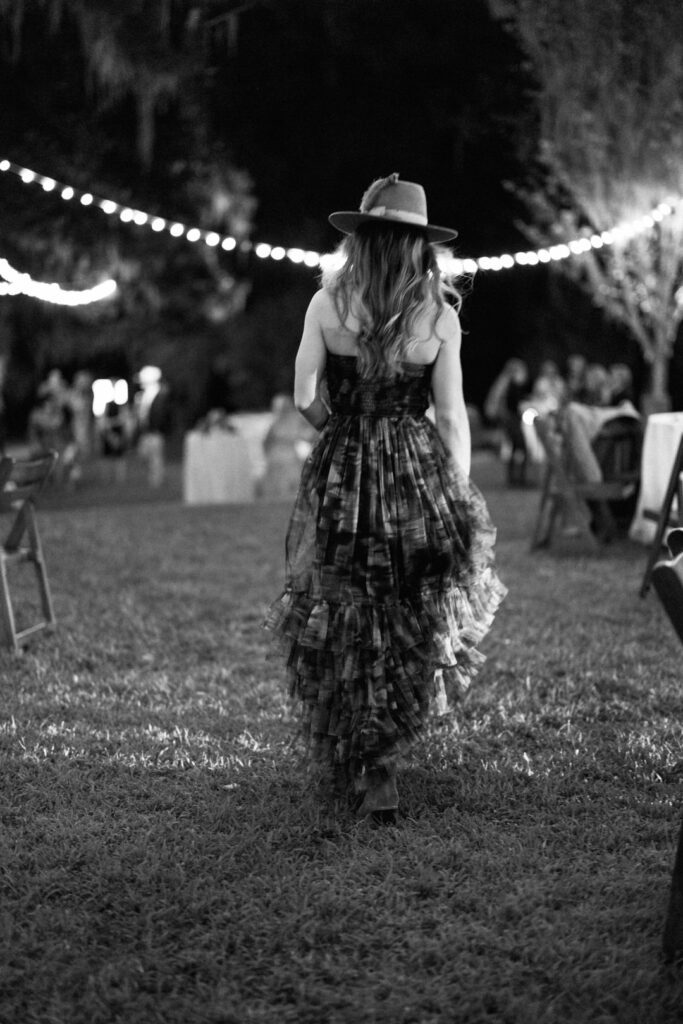 black and white of wedding guests walking 