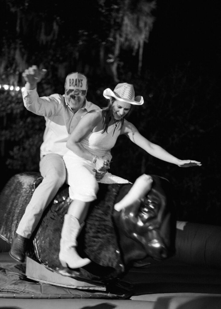 bride and groom riding mechanical bull 