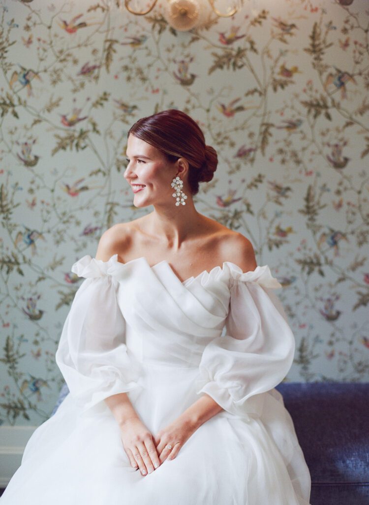 Bride Sitting on Bench Smiling at The Carolina Inn