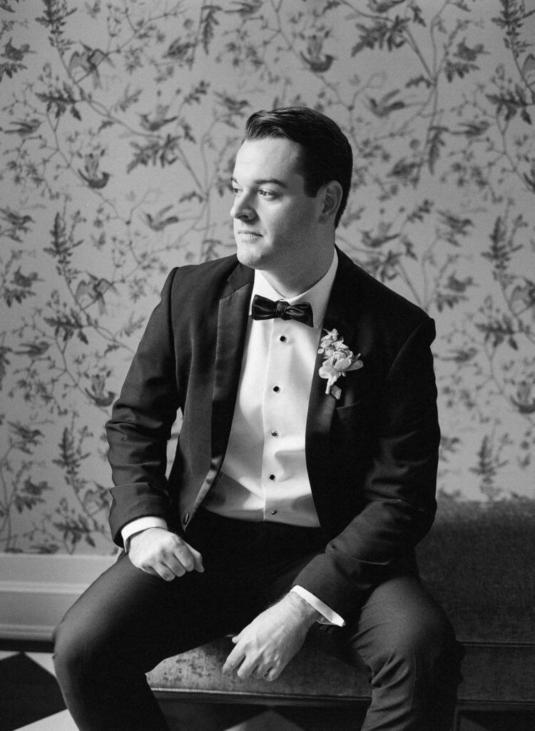 Black and White of Groom Sitting on Bench