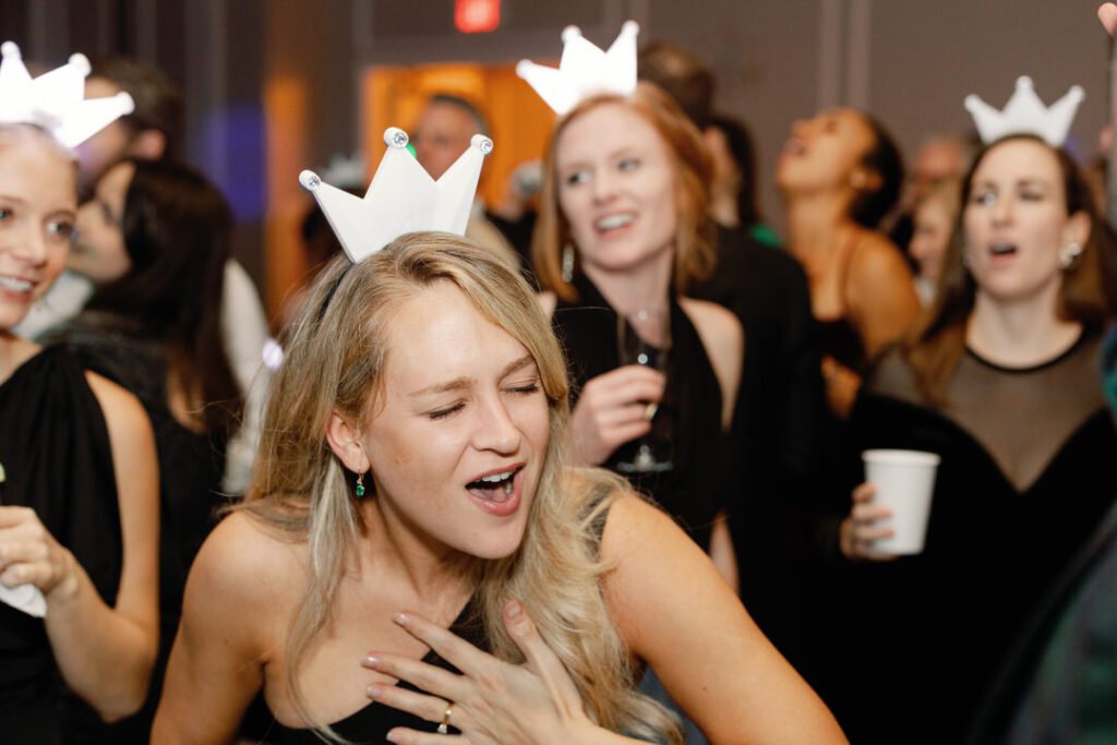 wedding guests dancing and singing at wedding reception